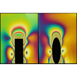 Photoelastic frozen stress images, showing matrix strain fields around short fibre reinforcements with ellipsoidal and cylindrical shapes, generated by an applied axial load